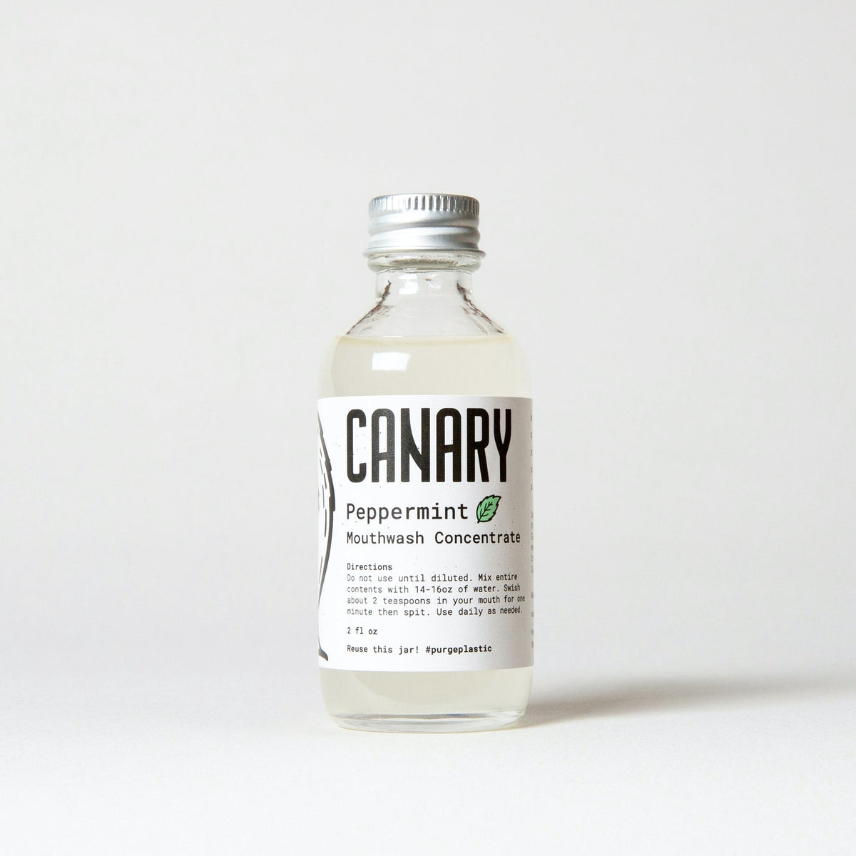 Canary peppermint mouthwash concentrate in a clear glass bottle