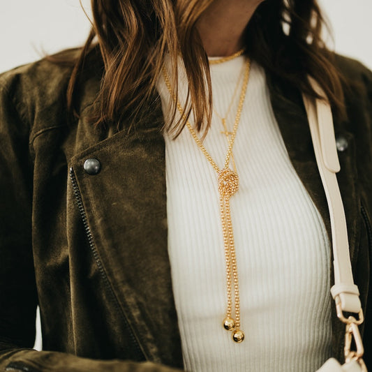 Gold-tone layered chain wrap necklace with textured center and long drop pendant