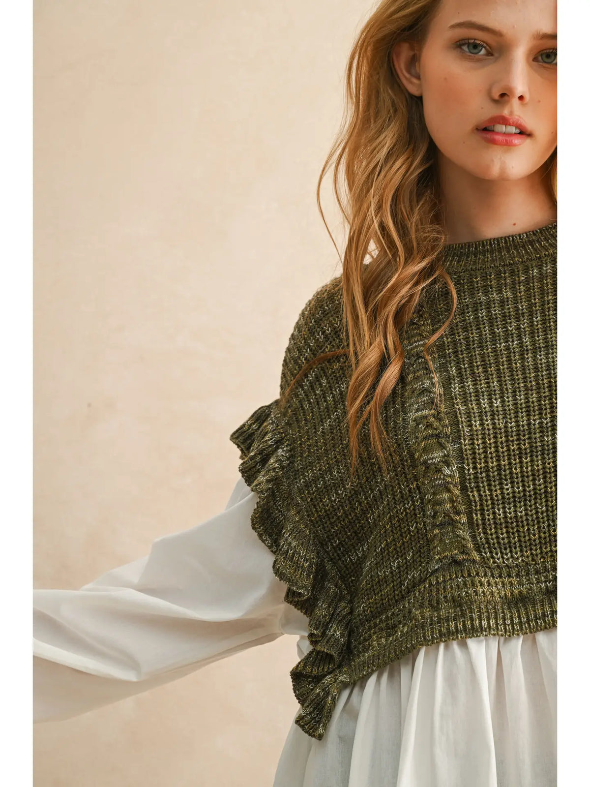 Sprig Top detail showing textured olive knit, ruffled sleeve trim, and white blouse fabric