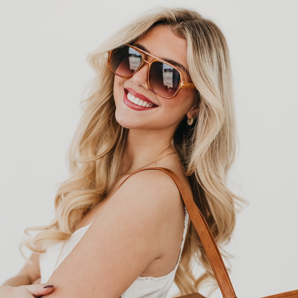 Oversized aviator sunglasses on model, tortoiseshell frame with dark tinted lenses