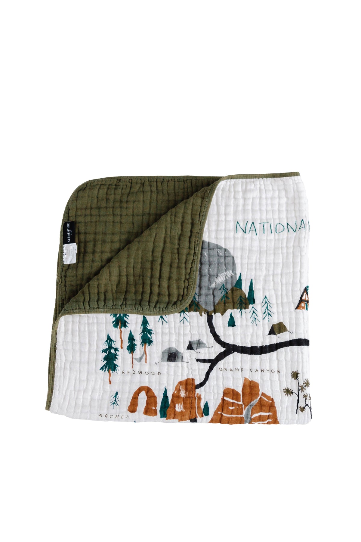National Parks quilt folded, white front with illustrated landscape and dark olive back
