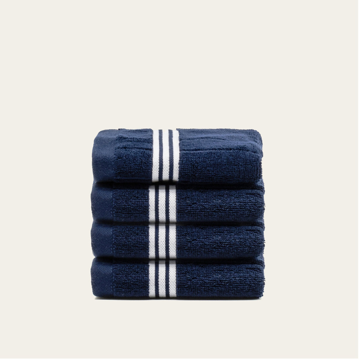 Navy towel stack with white triple-stripe bands and rolled top fold