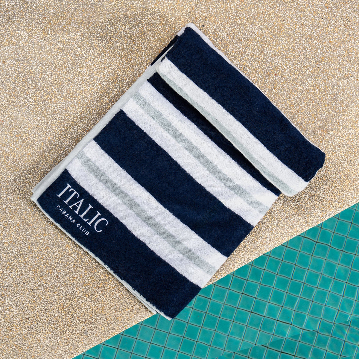 Navy and light gray striped cotton beach towel with ITALIC logo
