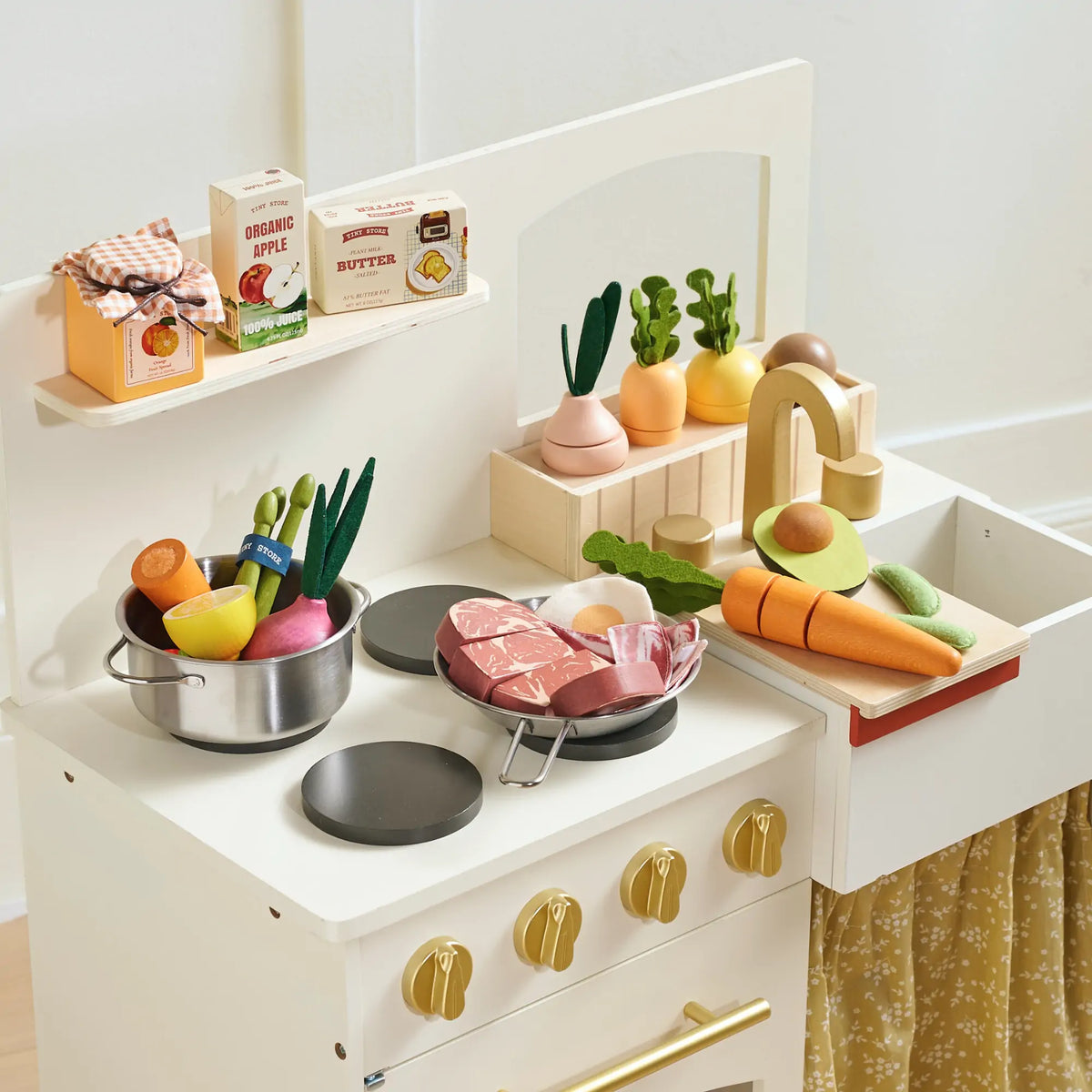 Play kitchen shelves stocked with organic meat and seafood toy pack pieces