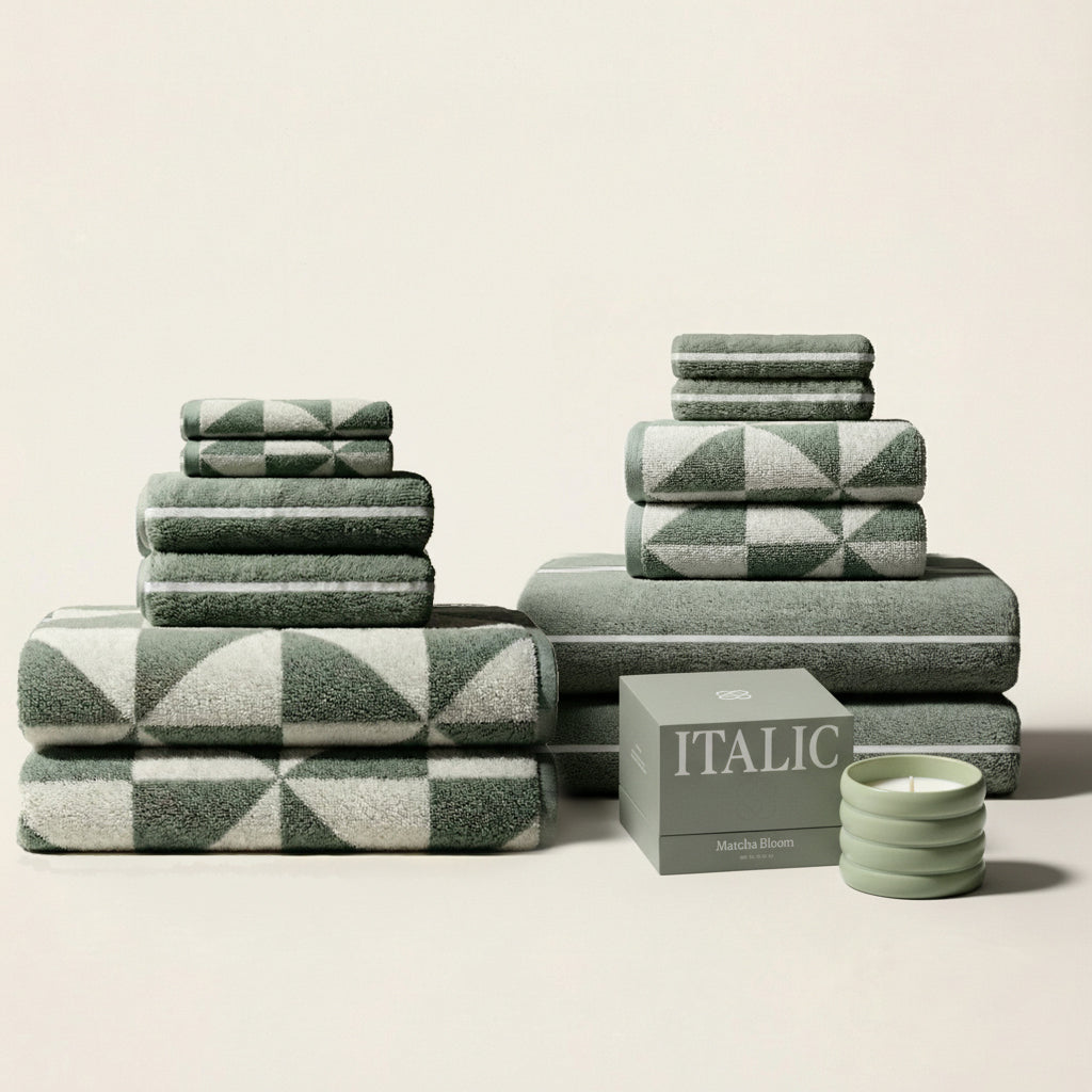 Sage green and ecru towels with geometric pattern, tiered folded stacks