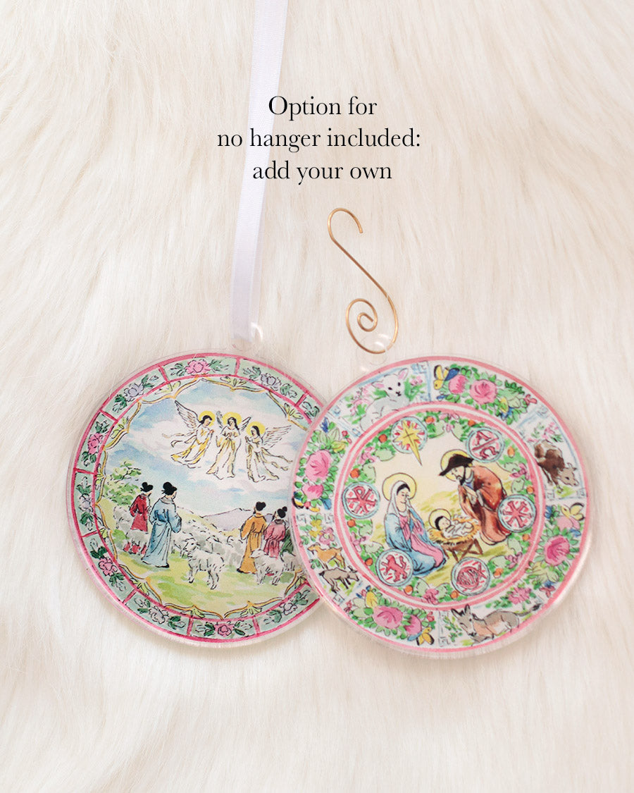 Two round acrylic ornaments with ornate scenes; one has a ribbon hanger and one has none