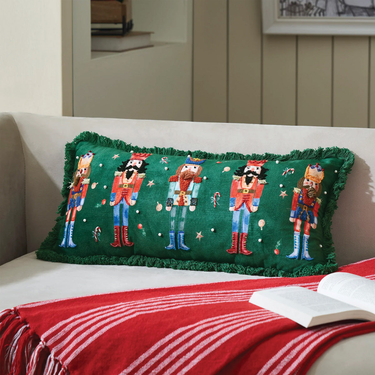 Green nutcracker decorative pillow with fringed edges and multicolor soldier print