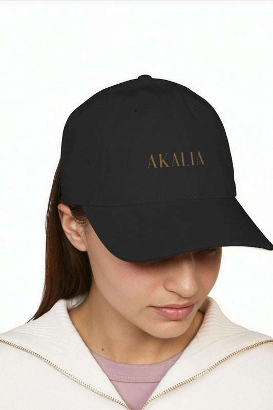 Black baseball cap with AKALIA logo, worn front view.