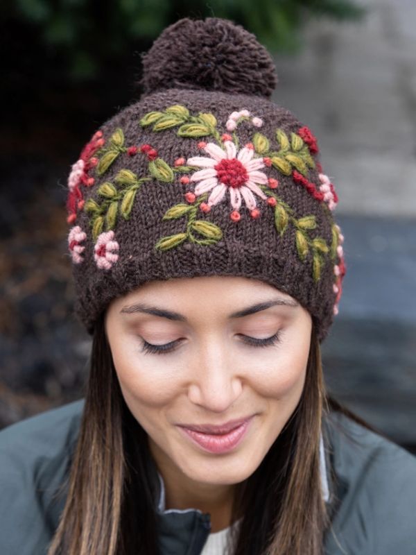 Wool knit embroidered hat in dark brown with pompom and floral stitching