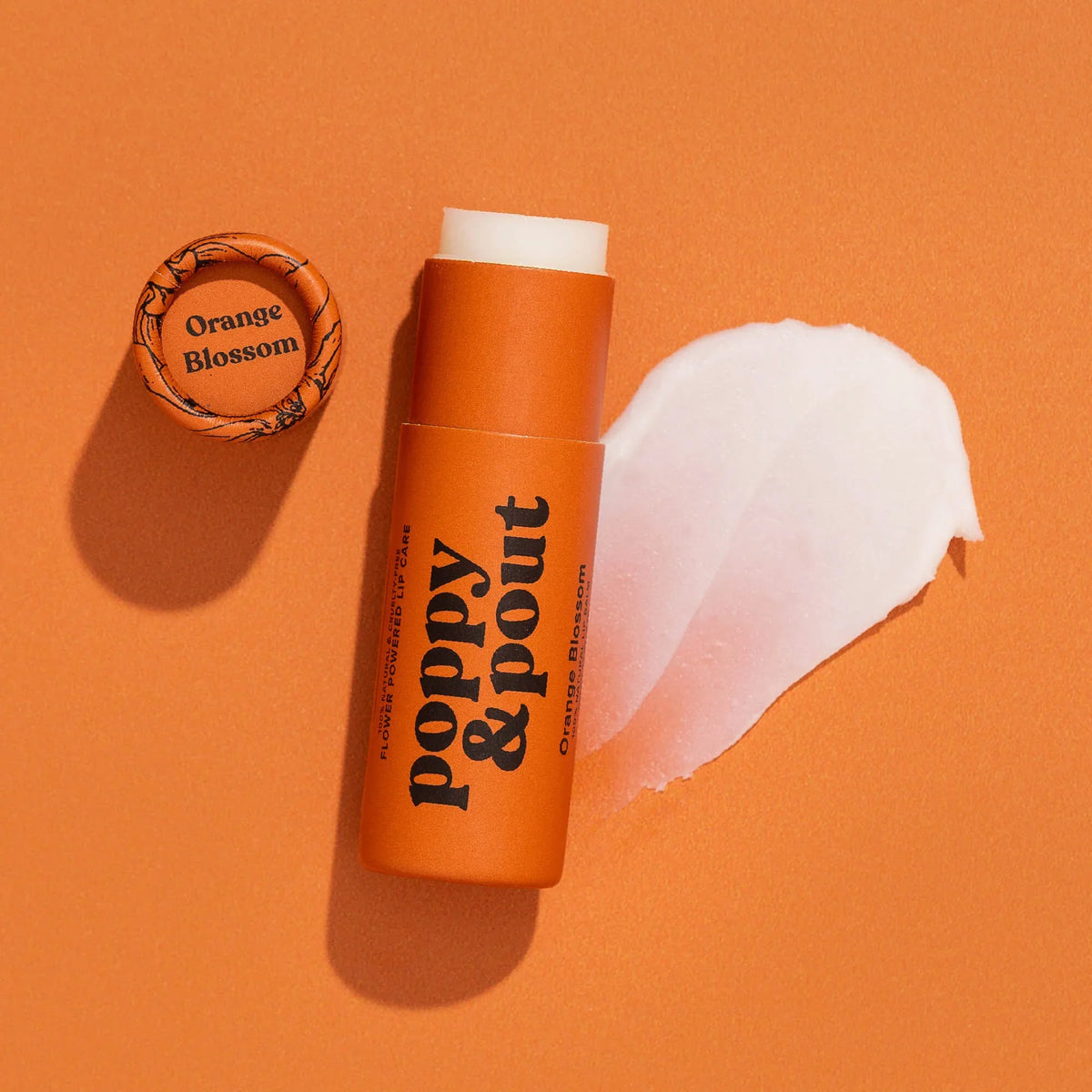 Orange blossom lip balm in orange tube with white cap and heart-shaped balm