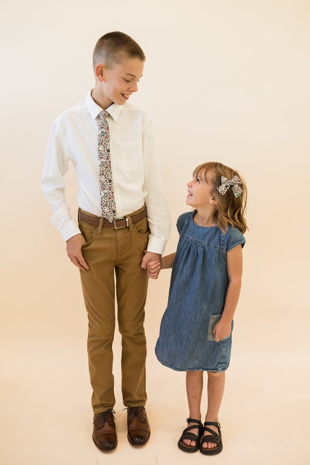 Youth skinny floral tie in cream, multicolor botanicals, worn with a button-down shirt