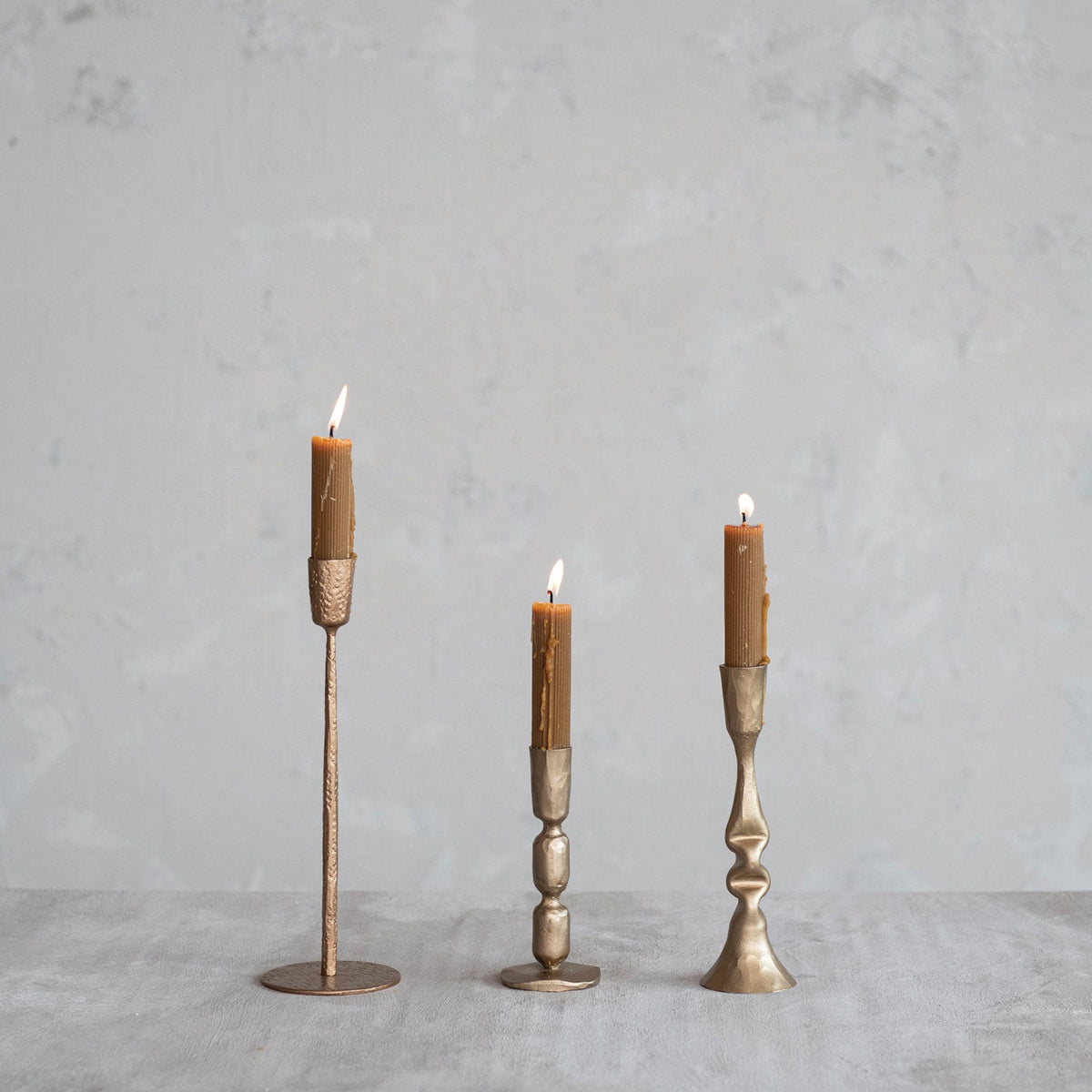 Antique gold metal taper holder set with candle sleeves