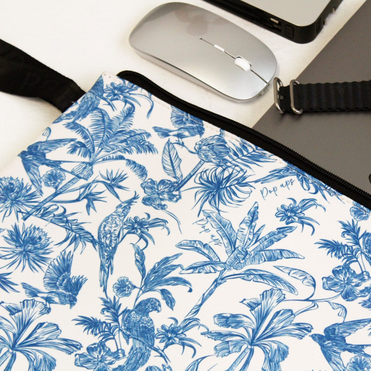 Close-up of blue and white toile laptop sleeve fabric and black zipper