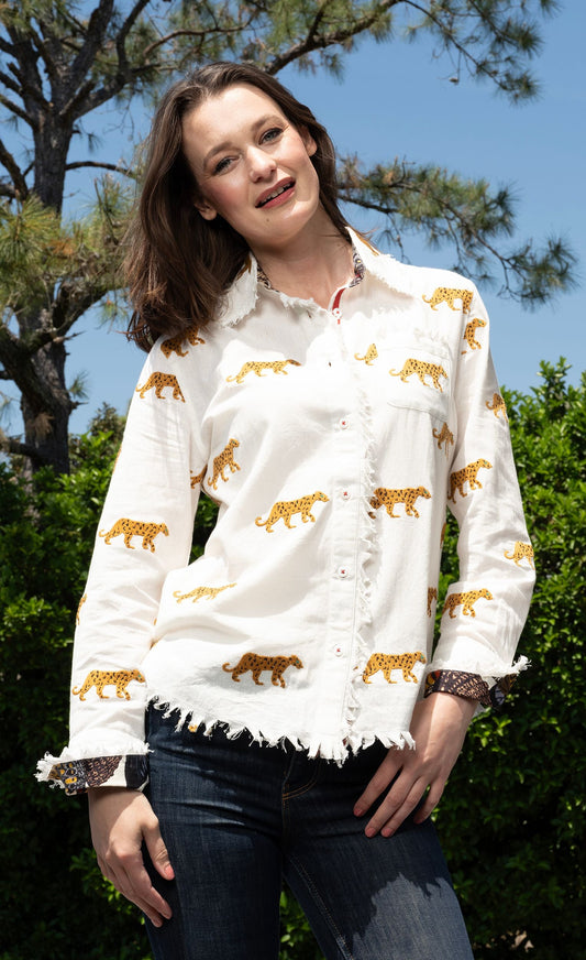 Ivory button-up top with cheetah embroidery, ruffled hem and cuffs
