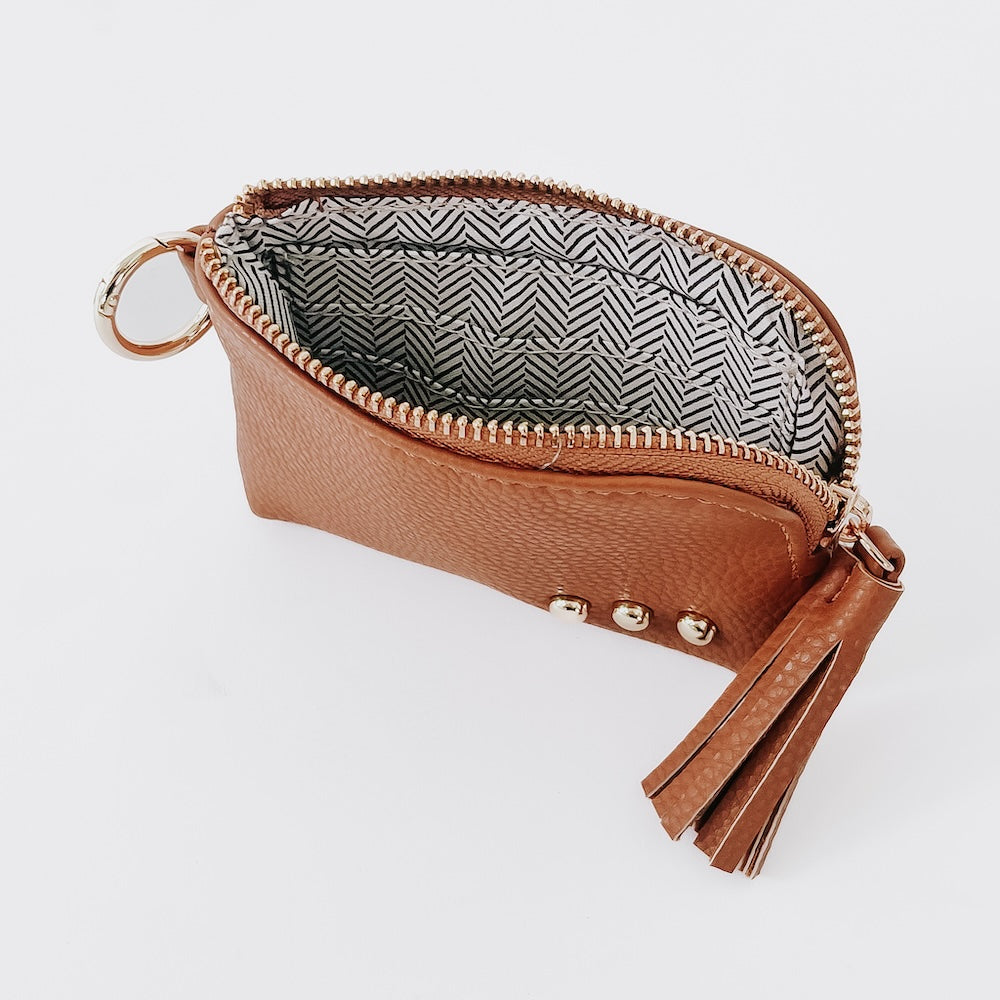 Brown leather card wallet with gold zipper, key ring, tassel, and logo charm.
