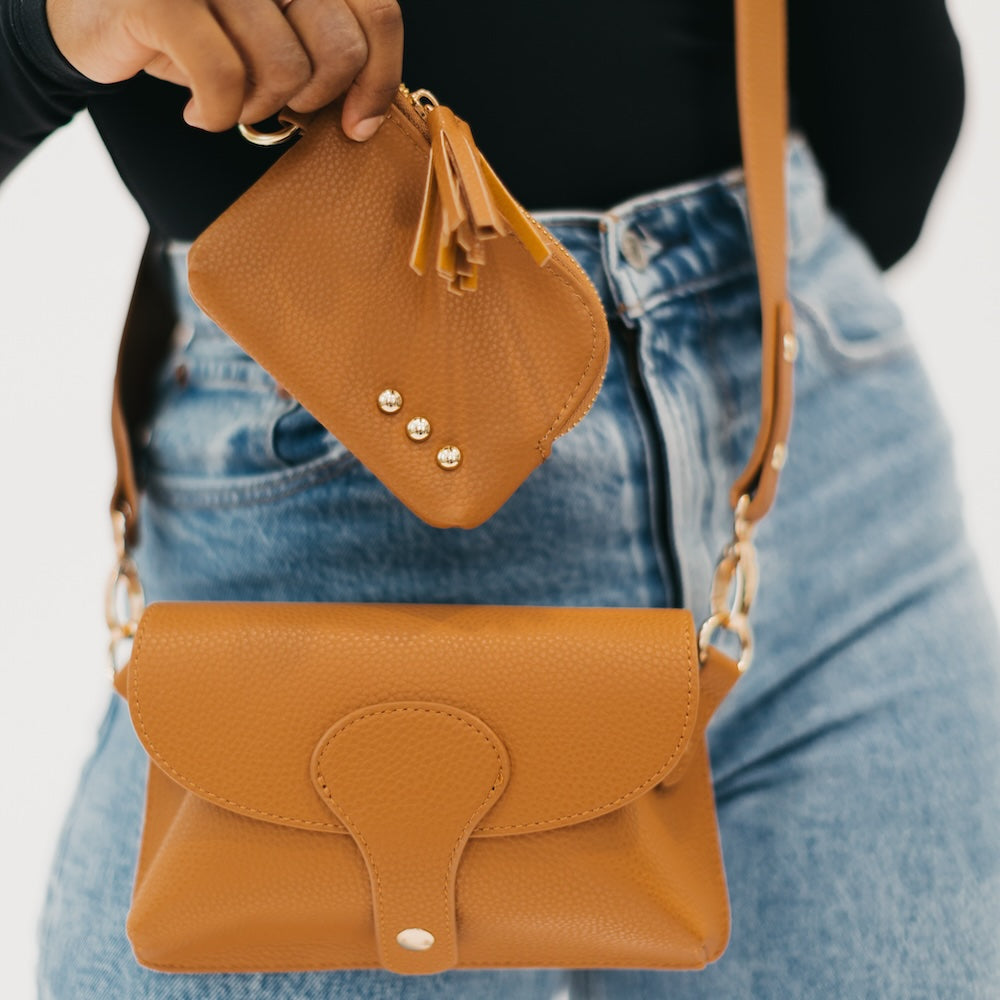 Tan/brown pebbled card wallet with tassel key ring and gold snap studs.
