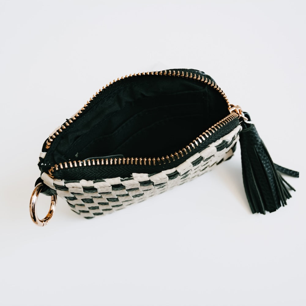 Dark card wallet with zip top, woven checkered lining, tassel, and key ring