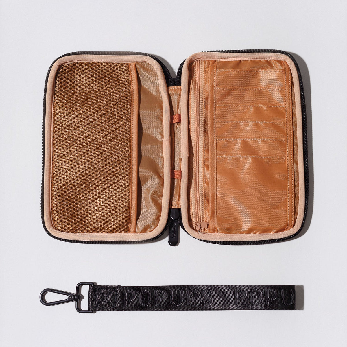 Open passport wallet with orange lining, mesh pocket, and black zipper edges