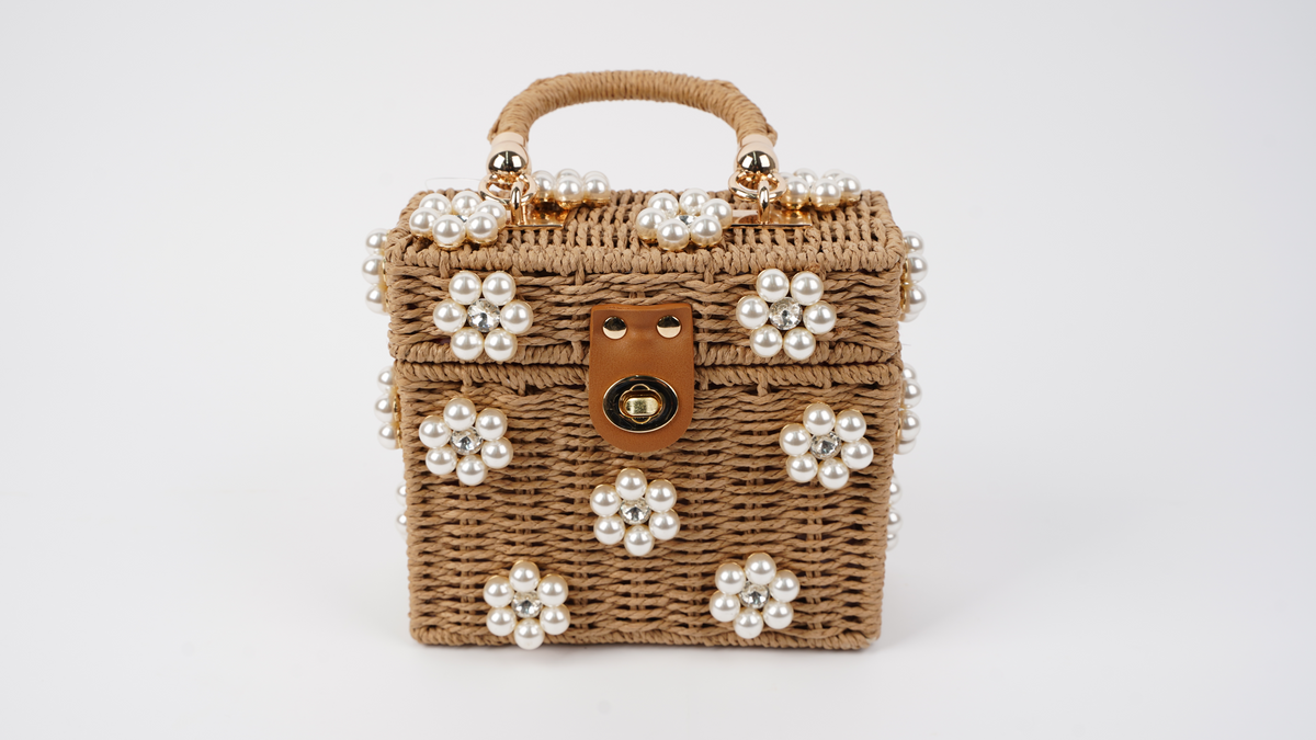 Raffia mini handbag with pearl flower embellishments, top handle, and gold clasp