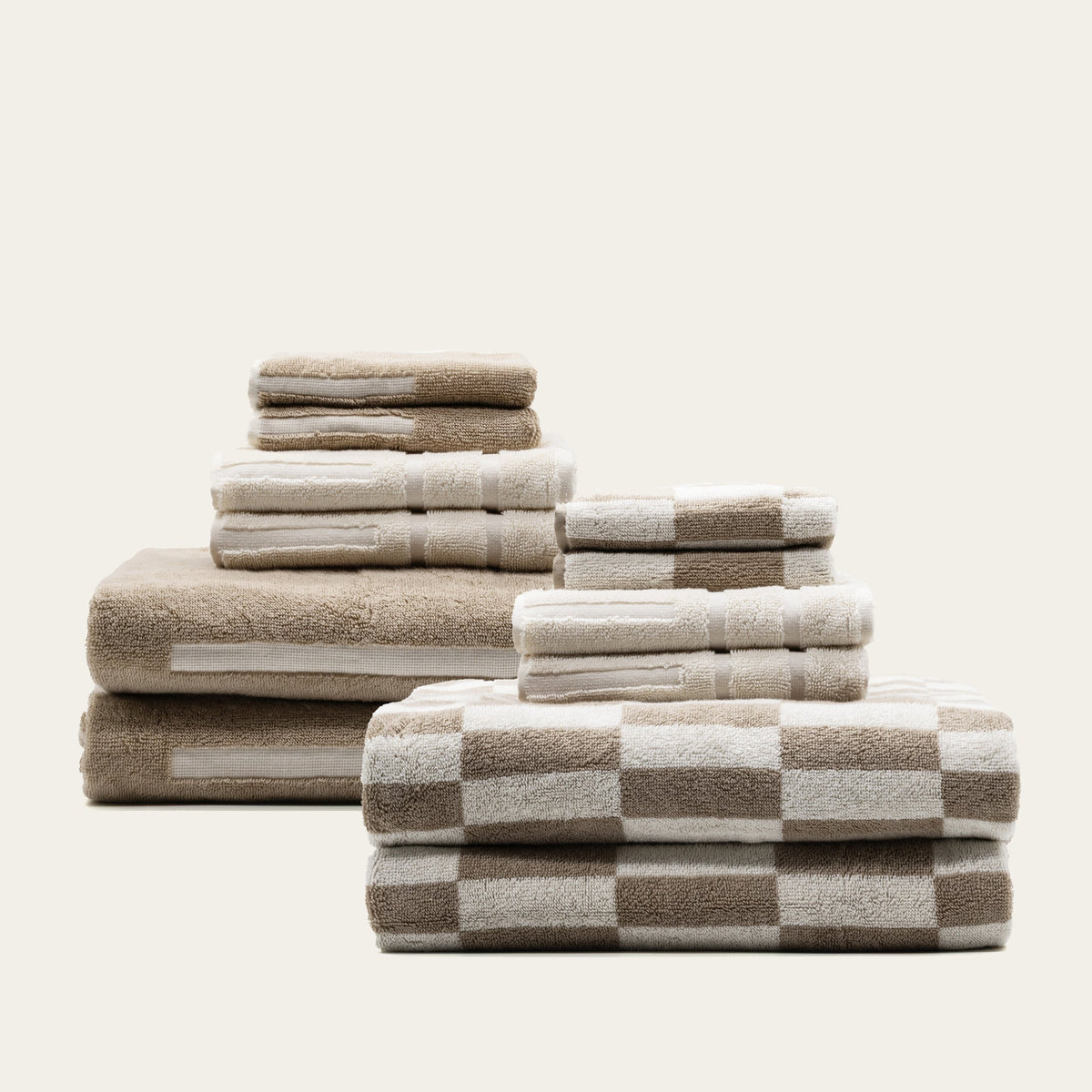 Australian cotton towels in tan and ecru with checkered pattern border, folded stack