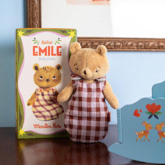 Plush bear doll in brown-and-white checkered dress with small bear beside
