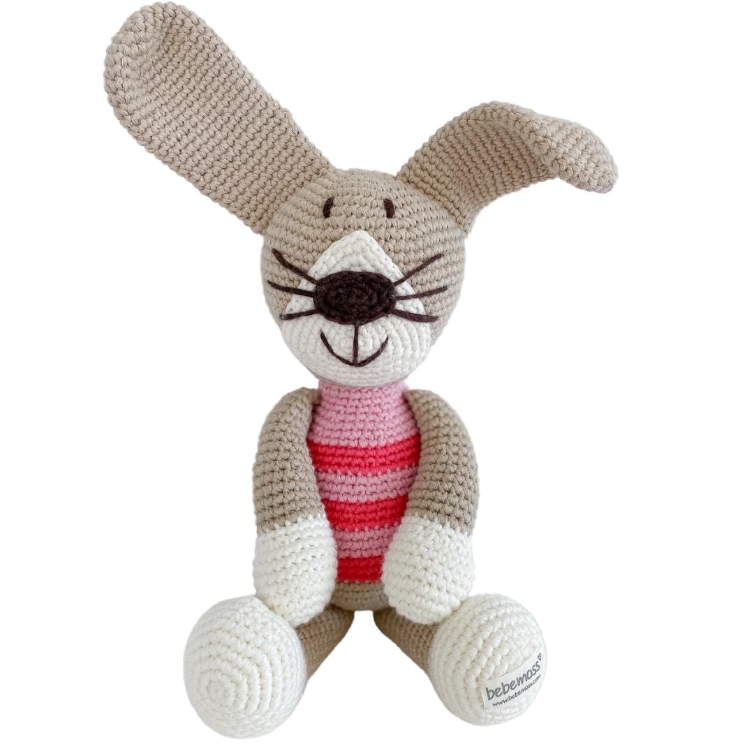 Crocheted rabbit plush with beige ears, white paws, and a pink striped shirt
