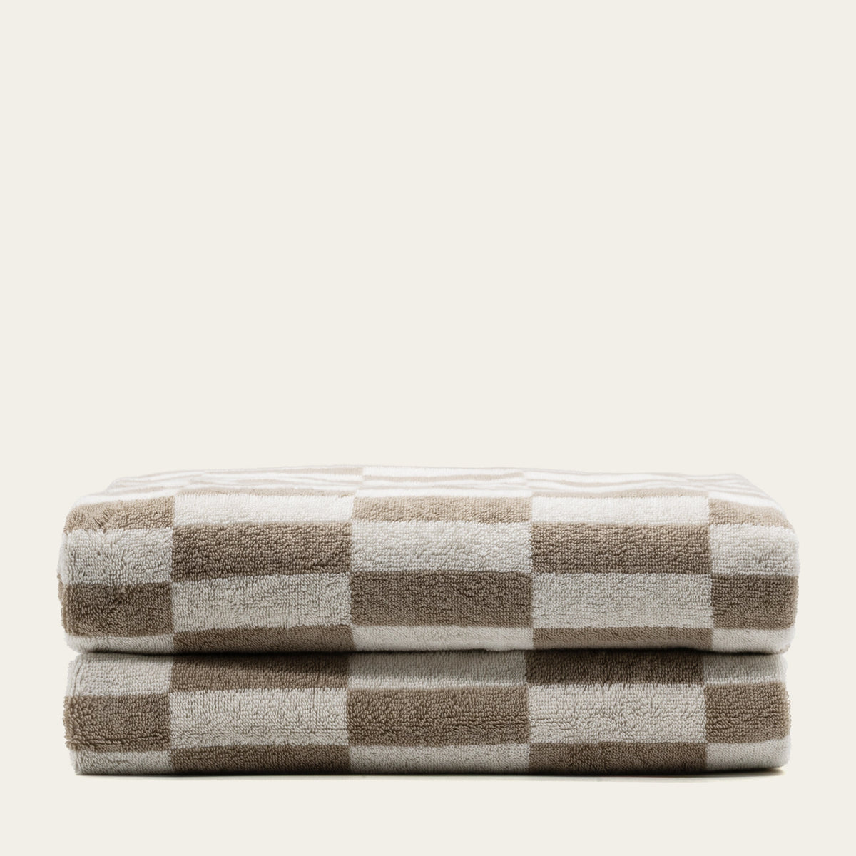 Checkered cotton towels in tan and ecru, folded stack of two