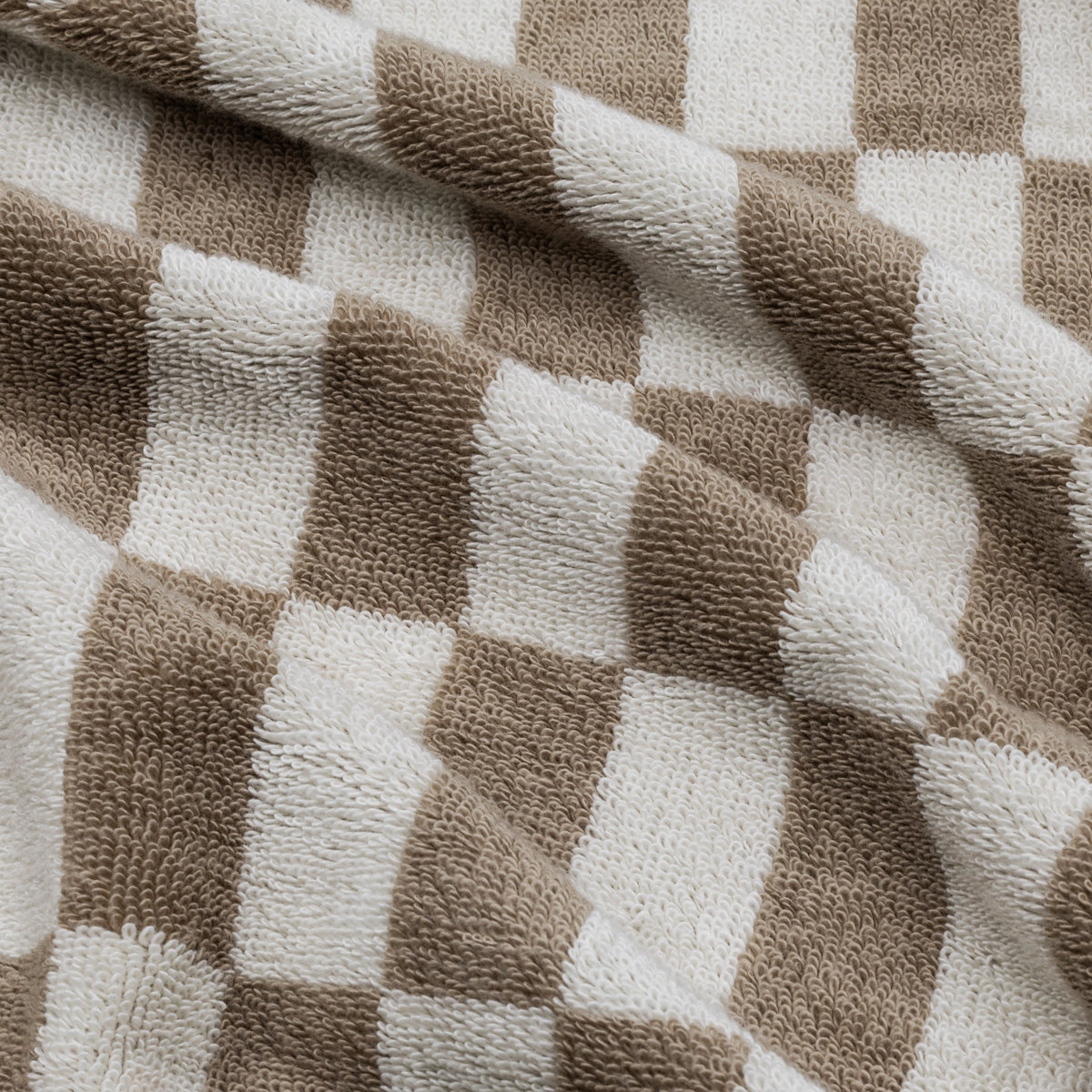 Close-up of woven check plaid cotton towel in beige and cream