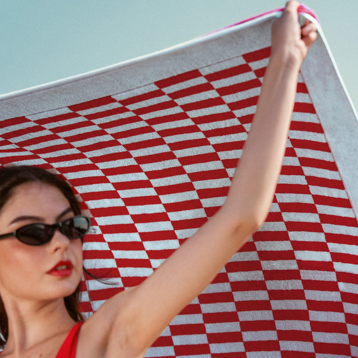 Large red and white checkered cotton towel, partly unfolded