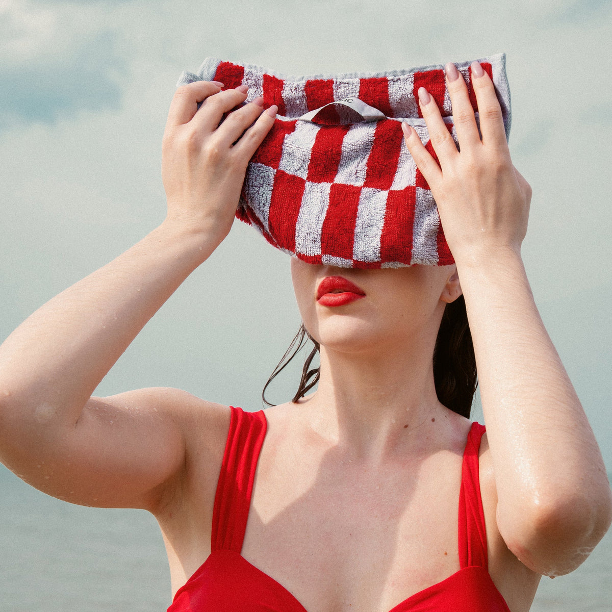Red and white checkered cotton towel with folded edge