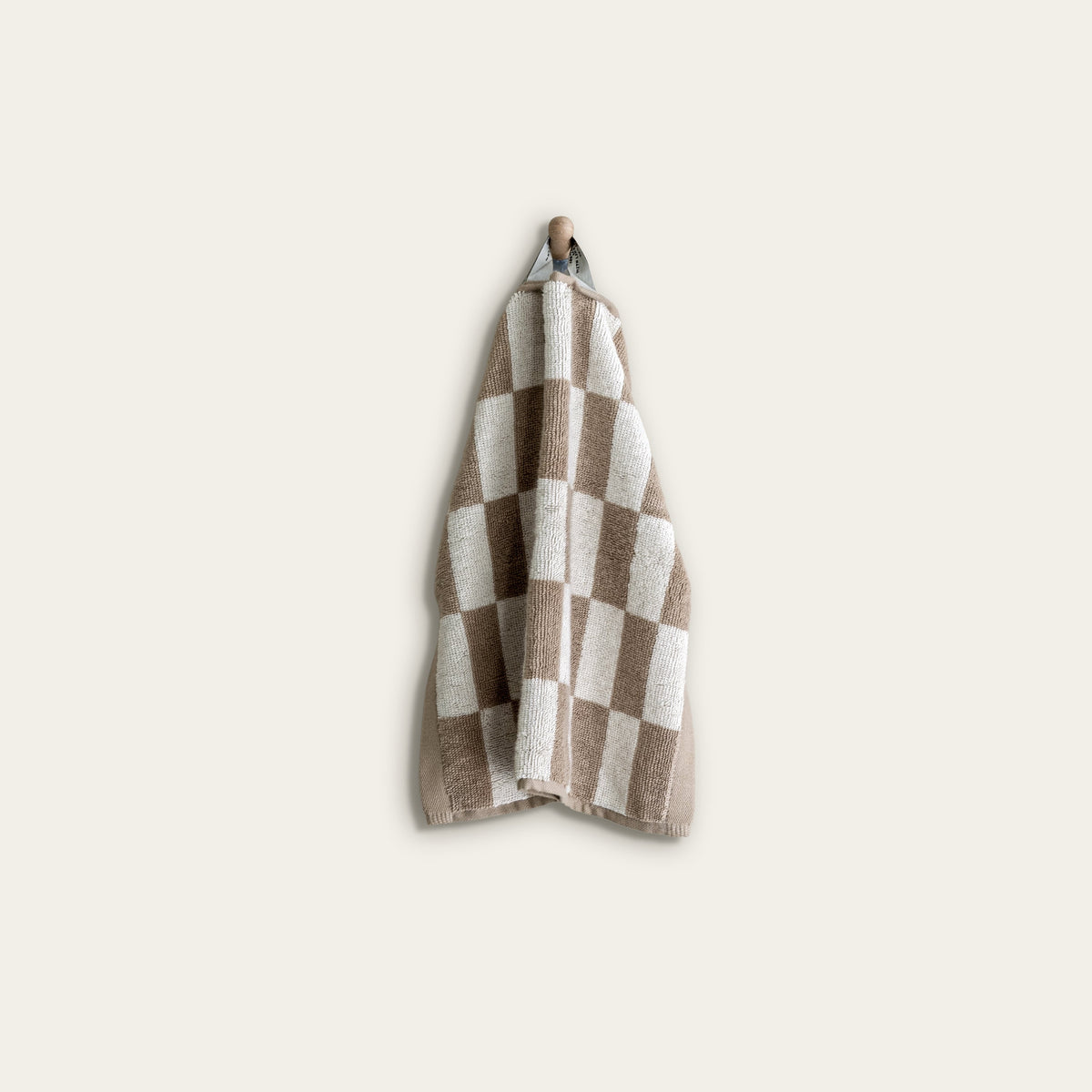 Tan-and-ecru checkered cotton towel neatly folded on display