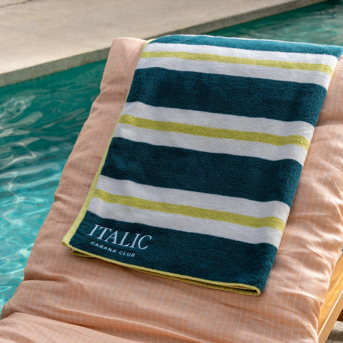 Navy, white, and yellow striped cotton beach towel with logo label