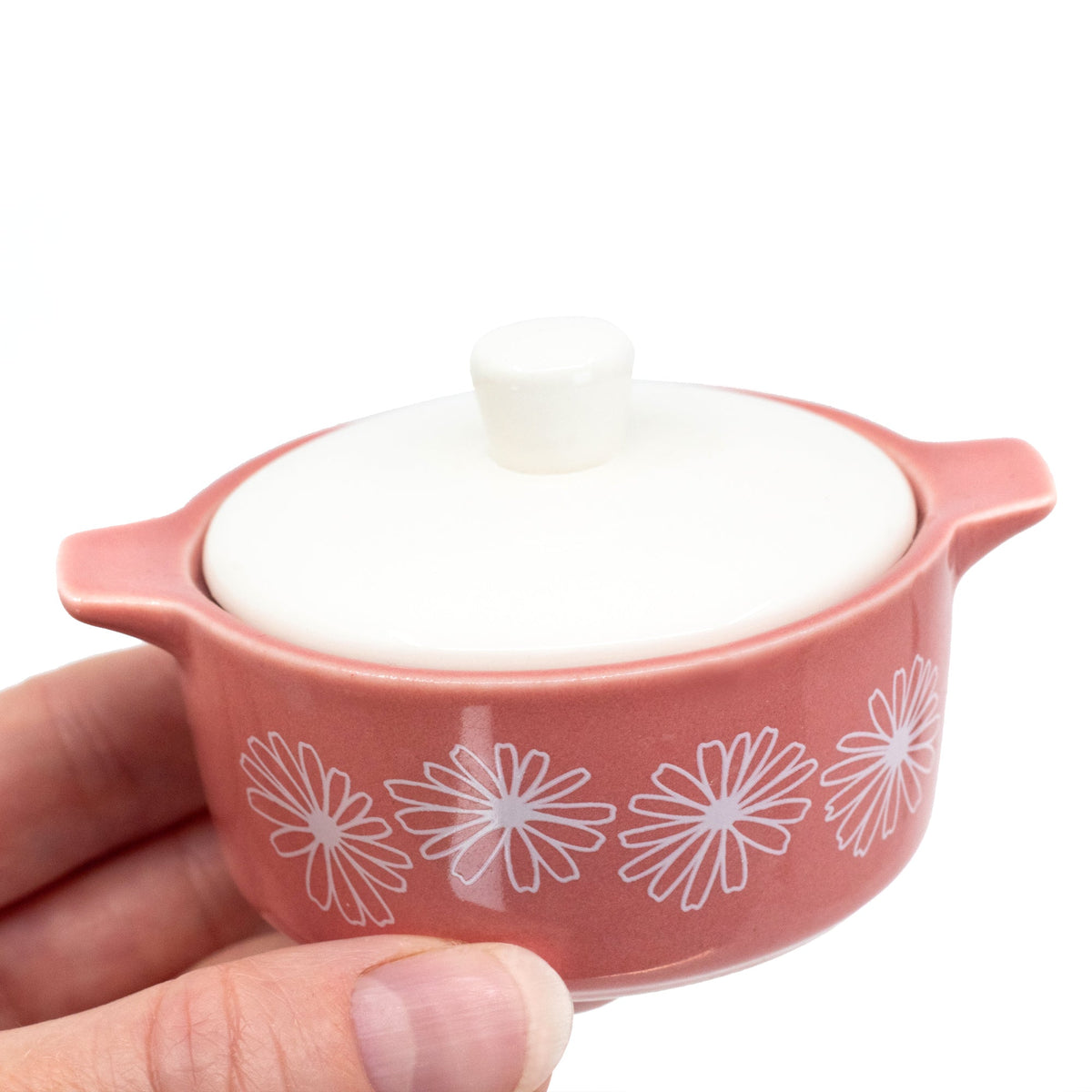 Pink ceramic casserole trinket box with white daisy pattern and knobbed lid