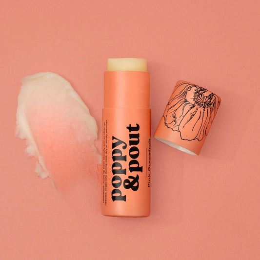 Pink grapefruit lip balm tube with yellow cap and peach-orange body