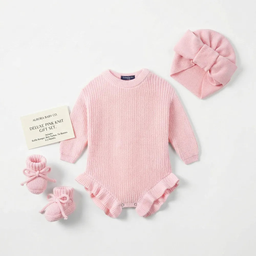 Pink chunky knit baby romper with ruffle cuffs and snap button bottom