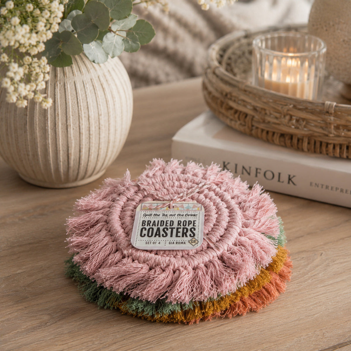 Pink braided rope tassel coaster round with fringed edges and braided center