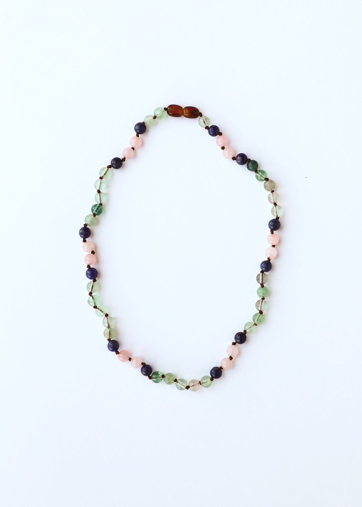 Gemstone bead necklace with green, pink, dark blue, and amber beads in oval shape