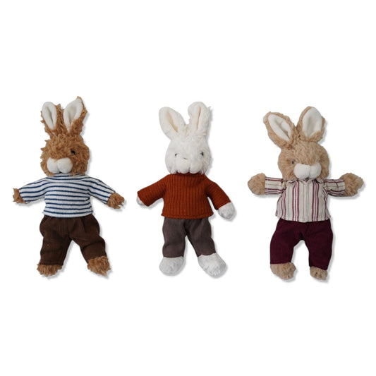 Three plush bunny toys in outfits: striped shirt, orange sweater, striped shirt