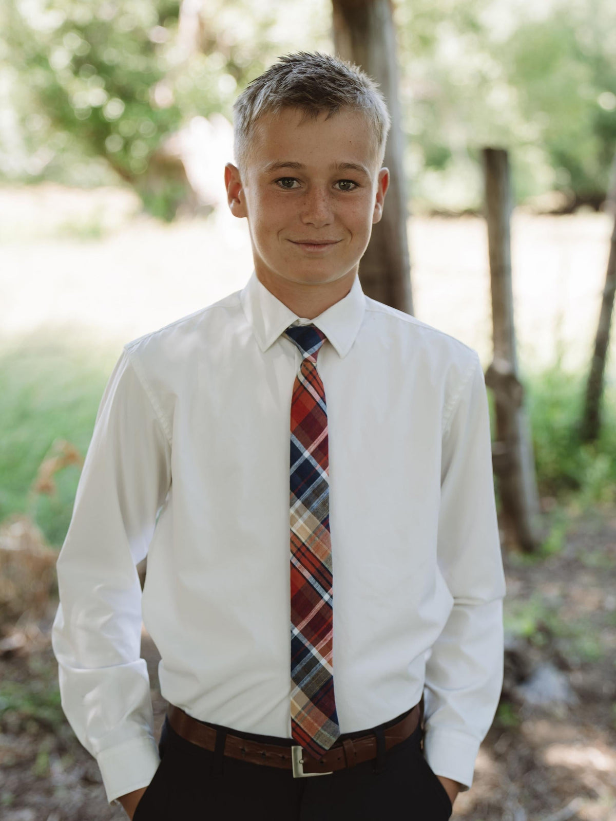 Boys plaid necktie with a white button-down shirt, red and blue stripe pattern.