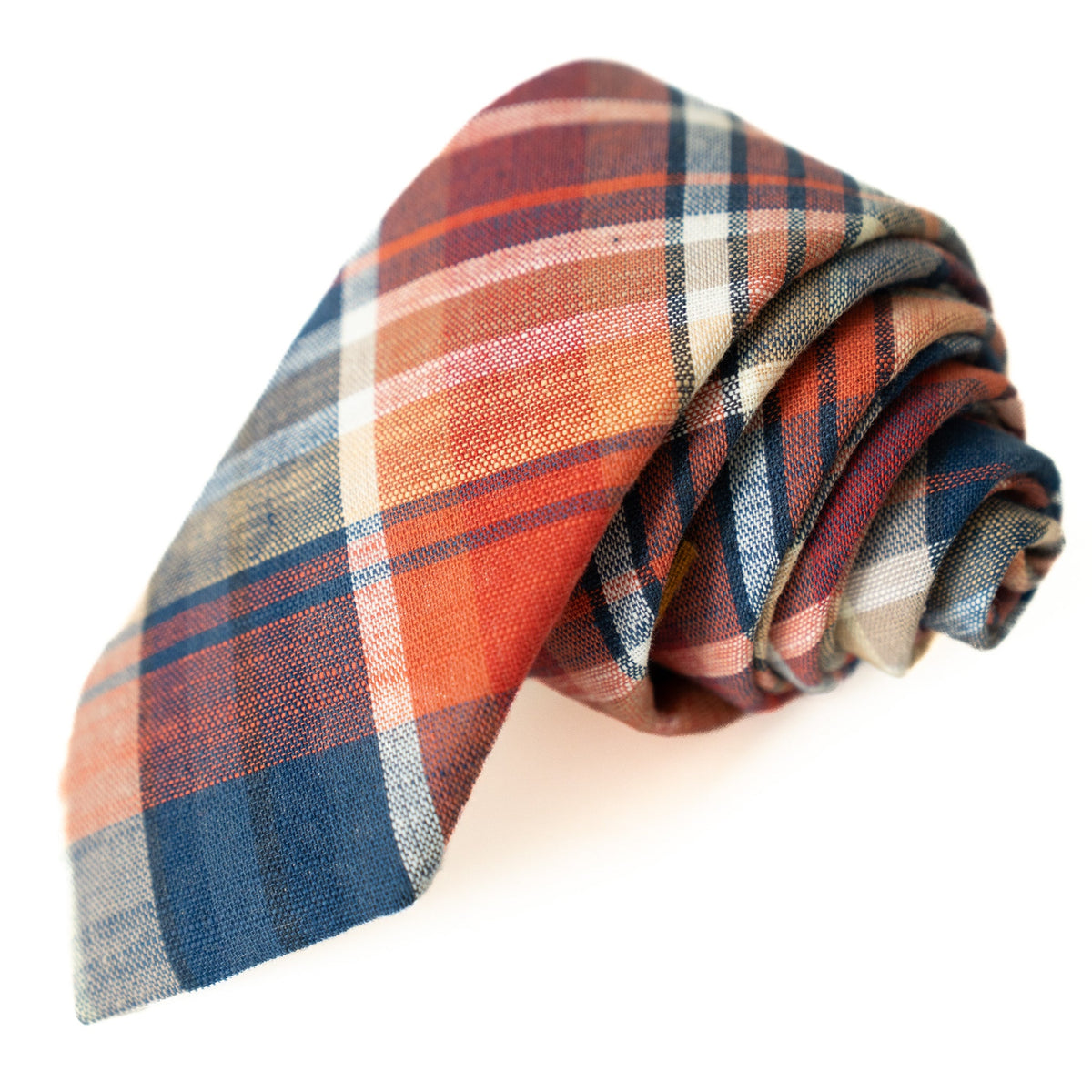 Men's plaid tie rolled up in orange, blue, and white checks with matching texture