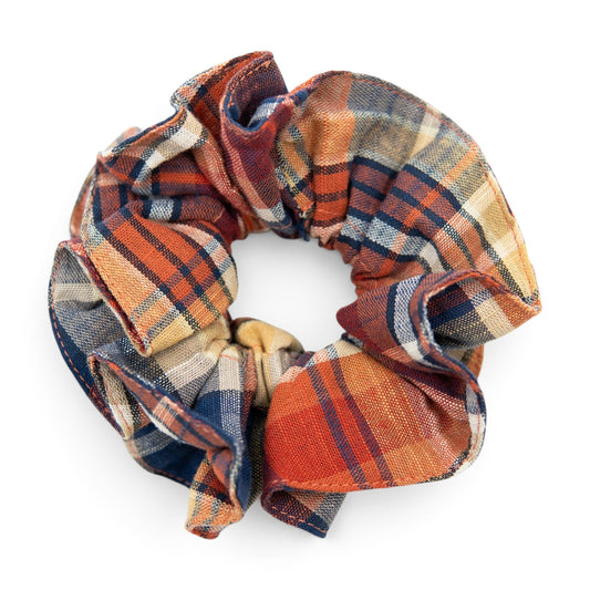 Plaid hair scrunchie with orange, navy, and cream patchwork pattern