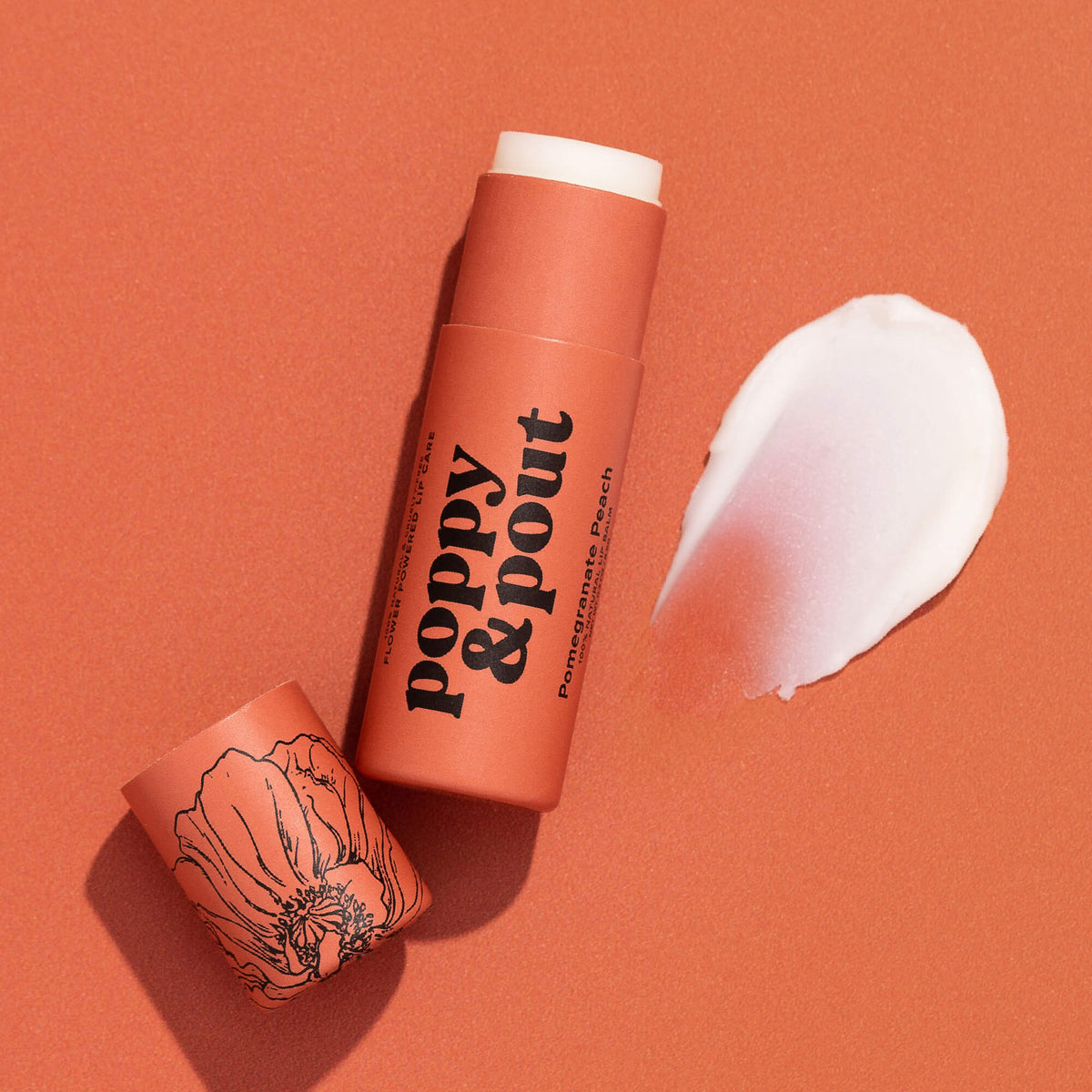 Poppy & Pout pomegranate peach lip balm tube with white balm smear
