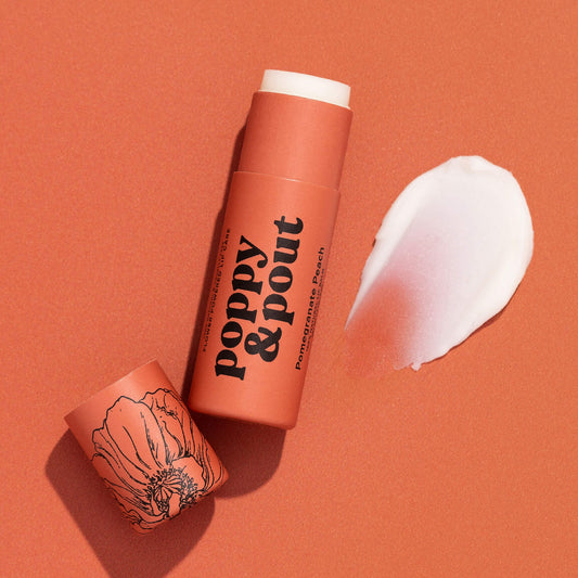 Poppy & Pout pomegranate peach lip balm tube with white balm smear