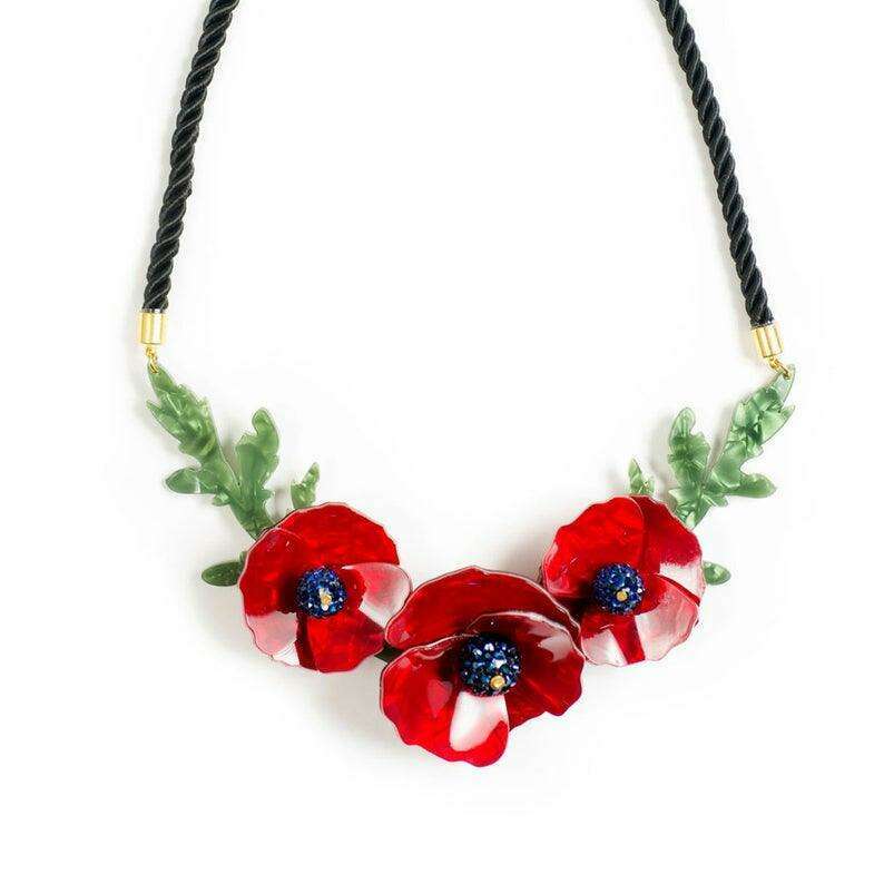 Red poppy flower necklace with green leaves, black braided cord, and gold hardware
