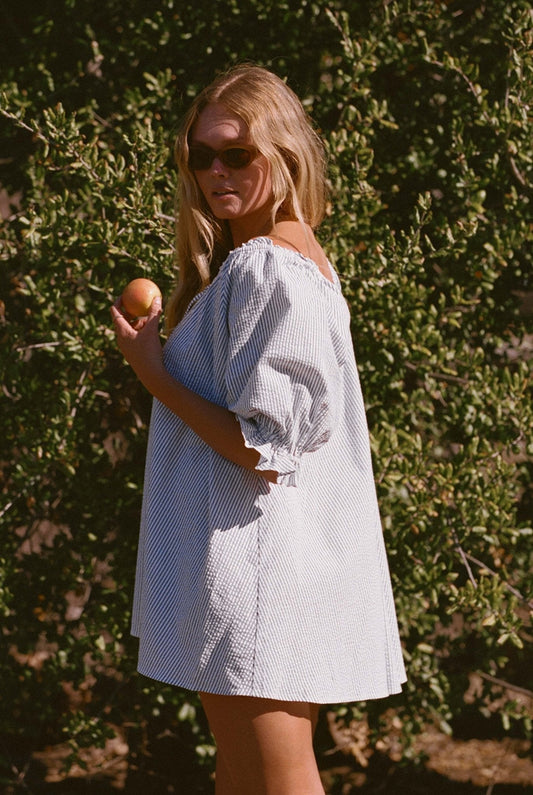 Blue-and-white pinstripe seersucker dress with puff sleeves and square neckline