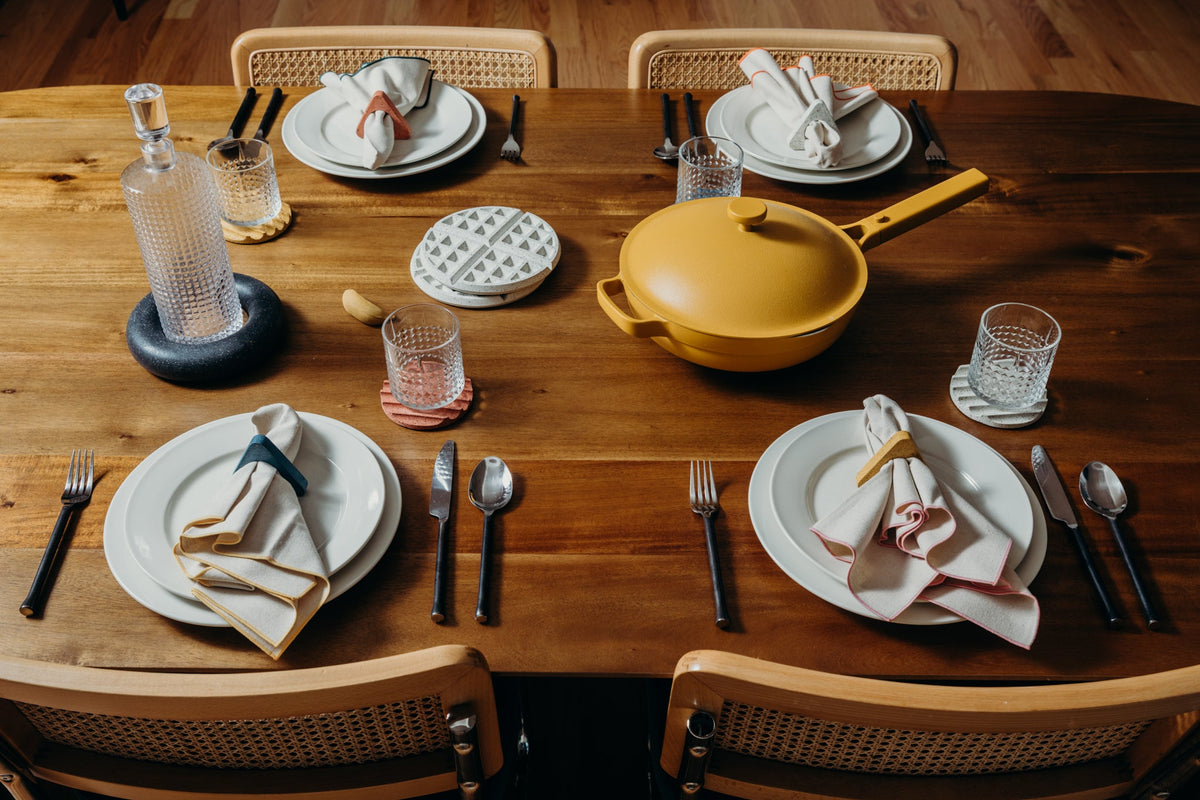 Round white terrazzo waffle trivets on a dining table
