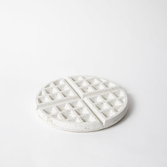 White terrazzo waffle trivet with raised square grid pattern