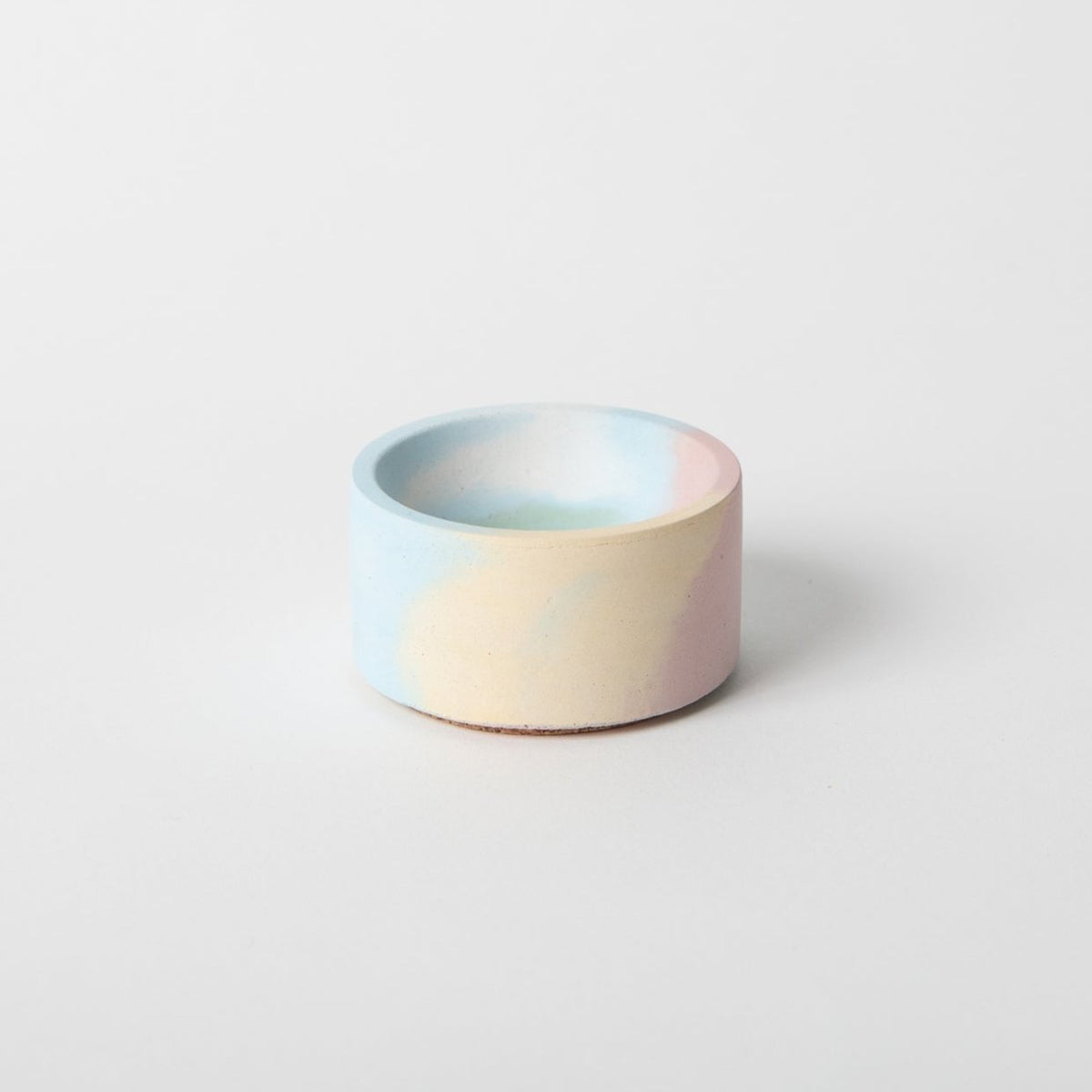 Round incense holder with pastel blue and pink rim, matte concrete finish