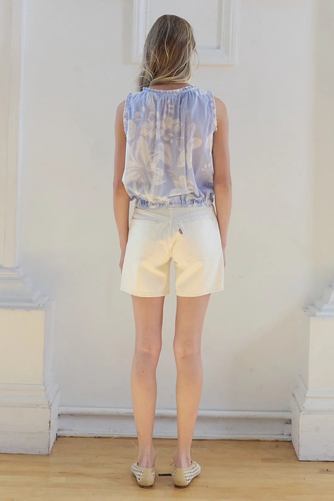 Plumeria Top back view in pale blue floral print with a gathered neckline and drawstring hem