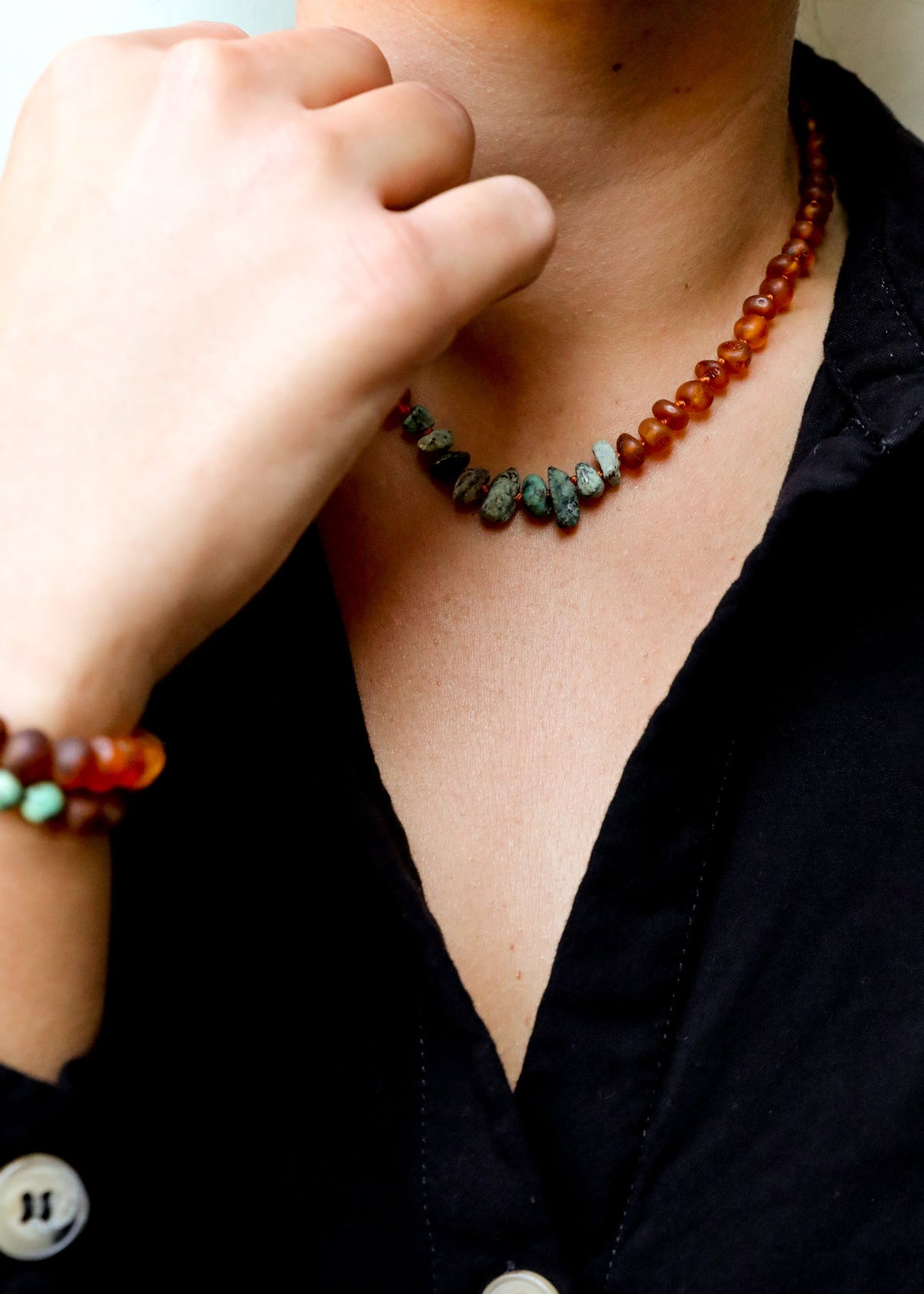 Turquoise jasper and cognac amber bead necklace, close-up at collar